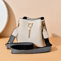 Elegant cream white bucket bag with golden cat ear ring and herringbone woven strap - Off-white