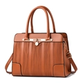 Elegant caramel brown textured handbag for women with dual handles and gold lock charm - Earthy Yellow