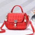 Red quilted crossbody bag with Mickey-style metal clasp and star pendant detail - Red
