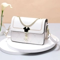White heart-quilted leather crossbody bag with iconic mouse clasp on white podium - Off-white