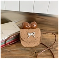 Macro detail of mini brown shoulder bag with heart pattern and large bow decoration - Khaki