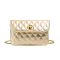 Close-up of golden quilted leather chain bag featuring an oval metallic turn-lock closure - Gold
