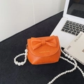 Mini oranje schoudertas voor meisjes met grote strik en elegante parel handvat - Oranje