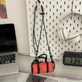 Mini orange cylindrical running bag with black mesh and adjustable rope strap - Orange / Small