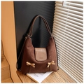 Detail of hobo bag showing brown suede texture with leopard print bows and logo - Brown