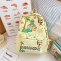 Cute yellow kids backpack with cartoon monkey and banana print in a cozy setting - Yellow