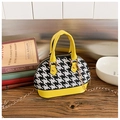Detail of mini shell bag showing houndstooth fabric and yellow leather handle with chain - Yellow