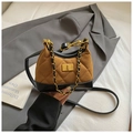 Detail of brown suede quilted mini bag with black leather trim and gold chain handle - Brown