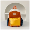 Close-up of vibrant color block kids backpack featuring durable fabric and side pockets - Large / Yellow