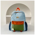 Detail of color-block nylon school bag featuring adjustable straps and durable side pockets - Large / Blue