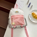 Pink and white kids' backpack featuring a trendy color-block design with a medal keychain - Medium / Pink
