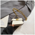 Chic cream mini shoulder bag with gold chain strap and decorative pompom on gray fabric - White Naked Bag