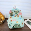 Light blue kids backpack with surreal cartoon prints and green Vacca Saturno text - Green