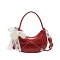 Red half-moon handbag featuring a pearl bow charm and minimalist leather texture - Red