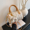 Beige Boston bag with cartoon cat print, brown handles, and cute dog charm accessory - Bare Bag / Set Yellow