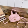 Pink mini crossbody bag for kids featuring a sweet bow and golden heart pendant - Pink