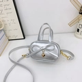 Mini silver crossbody bag for girls featuring a cute bow and golden heart charm - Silver