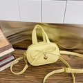 Mini soft yellow girls handbag featuring a large bow and golden heart metal pendant - Yellow