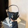 Detail of black mini bucket bag with leather trim and silver clasp on luggage - Black (Bag Only)