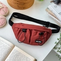 Flat lay of reddish-brown children's chest bag with dual drawstring pockets and black strap - Red