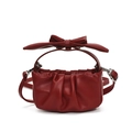 Red leather pleated crossbody bag with large bow handle and adjustable strap - Red