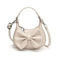 Cream white mini PU leather handbag for girls featuring a large bow and shoulder strap - White