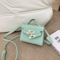 Mini mint green pebbled leather crossbody bag with top handle and gold turn-lock closure - Green