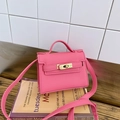 Mini hot pink pebbled leather crossbody bag with gold metal clasp and top handle - Pink
