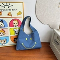 Kids cute blue denim crossbody bag featuring a vibrant yellow smiley face pattern - Blue Small