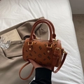 Detailed close-up of brown cylinder handbag with cute cat prints and gold hardware details - Small Without Pendant / Brown