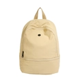 Minimalist beige nylon backpack for kids with a front zipper pocket and round logo patch - Khaki