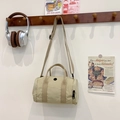 Minimalist beige cylinder shoulder bag for kids with black circular detail and long strap - Khaki