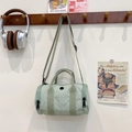 Mint green cylindrical crossbody bag with adjustable strap and top handle in a retro style - Bean Green