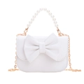 White mini handbag for girls featuring a large bow, pearl handle, and gold chain strap - White