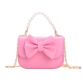 Pink girl's shoulder bag with a large bow, pearl handle, and gold chain strap - Rose Pink