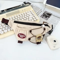Detail of canvas kids waist bag with fashion embroidery and decorative drawstrings - White
