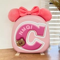 Detail of pink hardshell kids backpack featuring plush ears and decorative bow - Pink