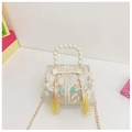 Detail of floral embroidery on a mini white handbag with pearl handle and tassels - Beige