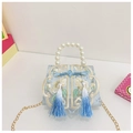 Close-up of light blue kids handbag with pearl handle, embroidery, and tassel detail - Blue