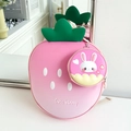 Close-up of strawberry-shaped backpack with cute bunny coin purse on white background - Pink