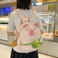 Pink capybara backpack with green turtle pouch and plush charm on female model - Light Pink without Pendant