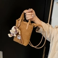Brown suede crossbody bag featuring a leopard bow teddy bear charm and twin handles - Brown