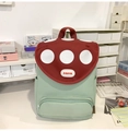 Detail view of cartoon mushroom backpack with red polka dot lid and mint green canvas body - Without Pendant / Green
