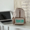 Minimalist milk tea colored kids backpack with green embroidery in school setting - Khaki
