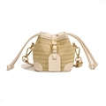 Fashionable bohemian straw bucket bag with cream faux leather trim and golden metal hardware - White