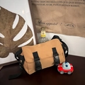 Detalle de bandolera de lona caqui con hebillas dobles y correa de hombro ajustable - Caqui