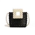 Handcrafted black beaded crossbody bag with elegant white pearl handles and long strap - Black and White