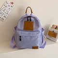 Lavender canvas children's backpack with leather handles and cute smiley face design - Purple