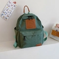 Forest green canvas kids backpack with brown leather smiley patch and side pockets - Green