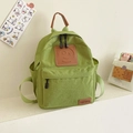 Avocado green canvas backpack for kids with a leather smiley face patch and side pockets - Fruit Green